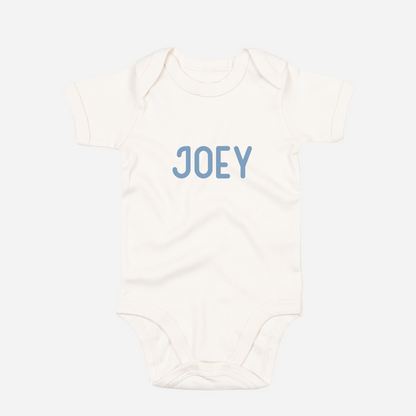 Personalised organic baby bodysuit in organic natural with custom text